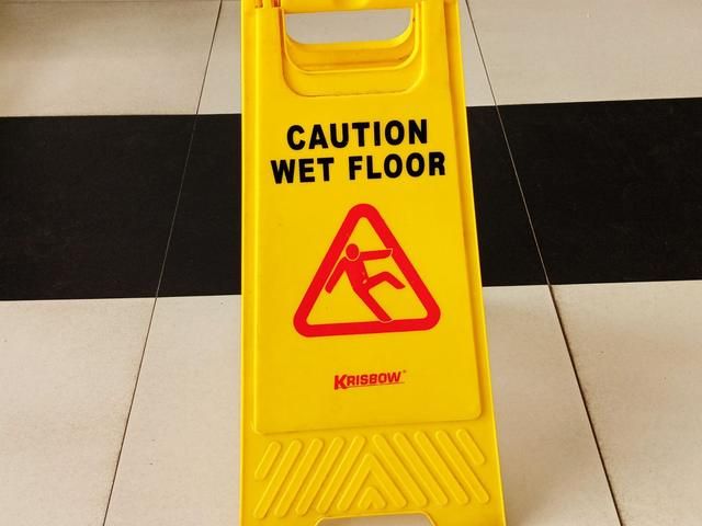 Caution wet floor sign on clean tiles