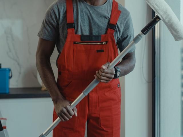 Cleaner ready with a window squeegee